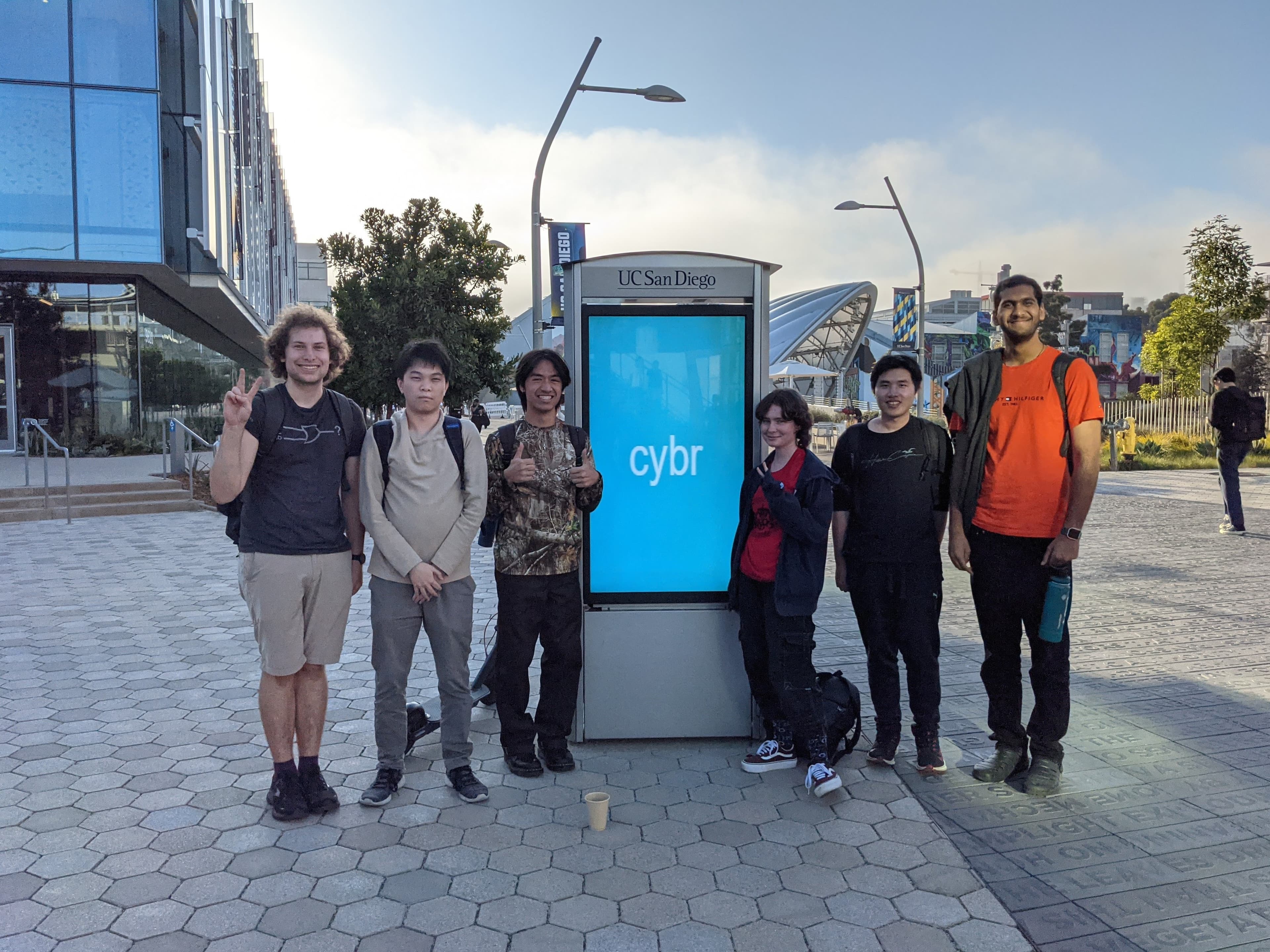 ACM Cyber Board stands in front of a UCSD kiosk set to display "Cyber"